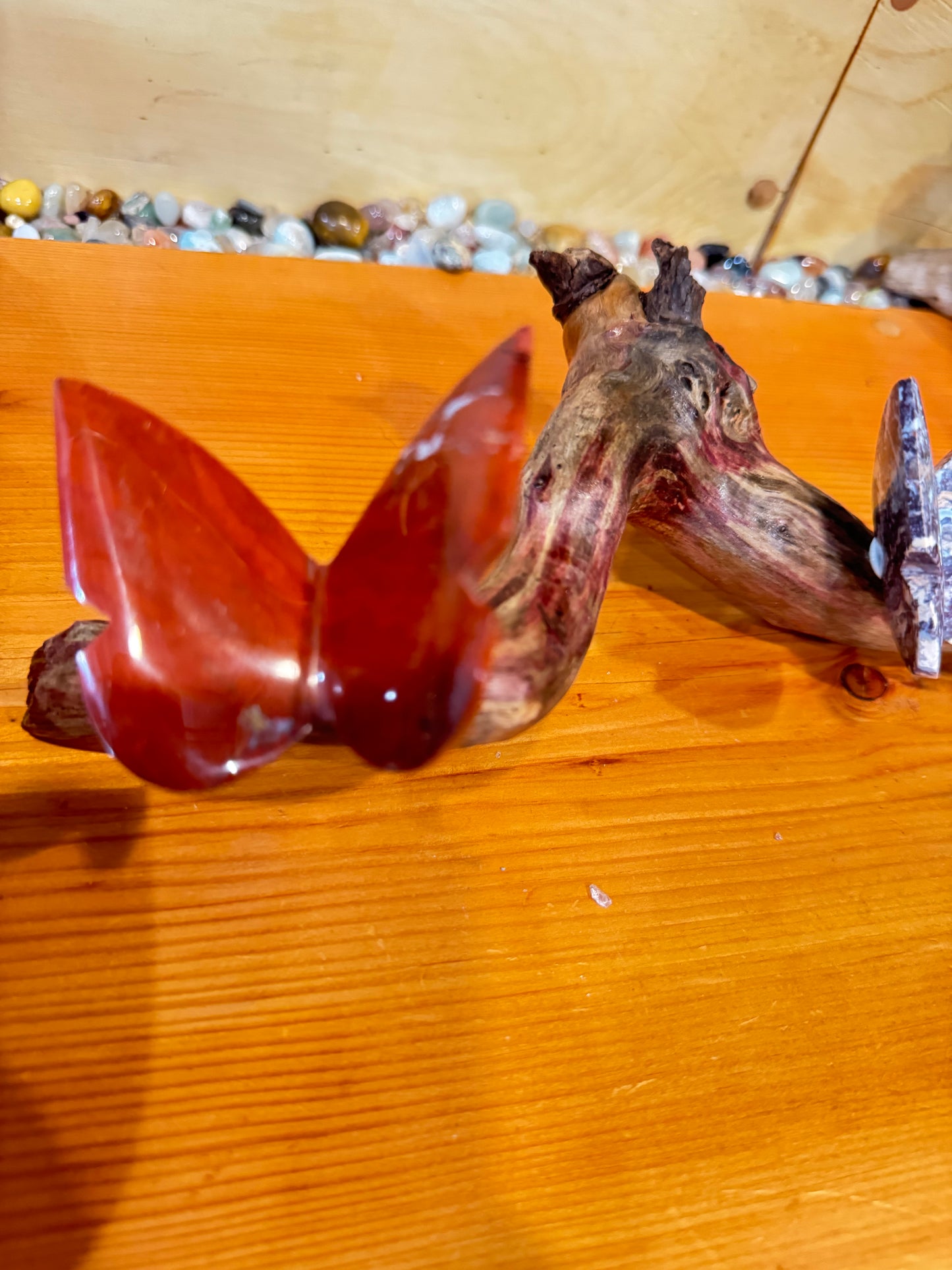 3 Stone butterflies fixed on a piece of drift wood